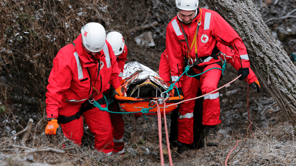 EMS volunteers coming out of the woods with Spencer Shell